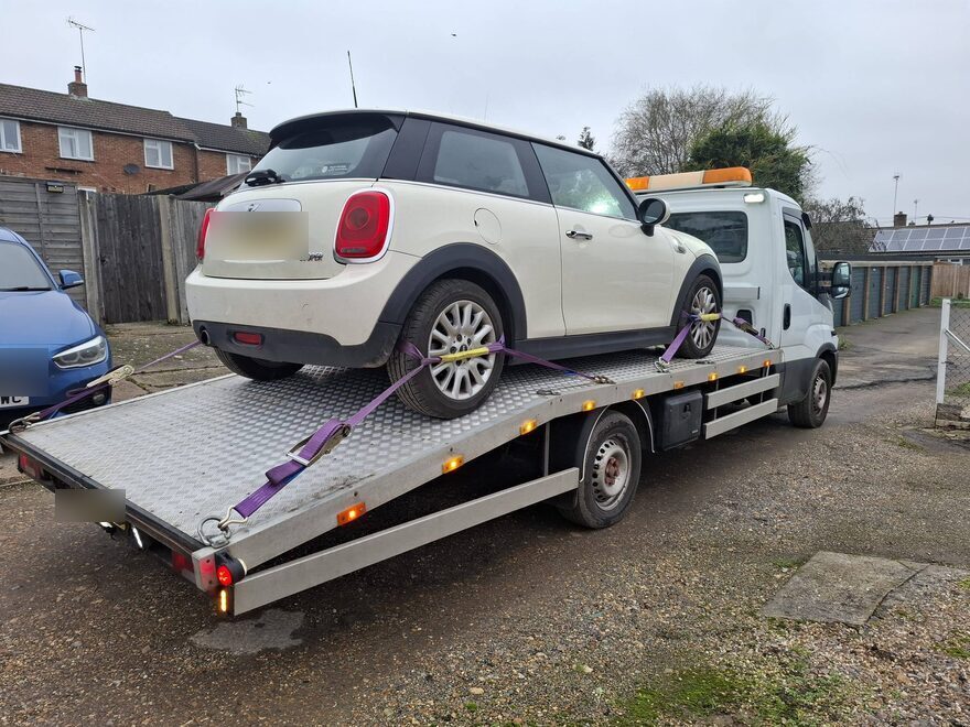 Mini Cooper secured on the recovery truck for collection